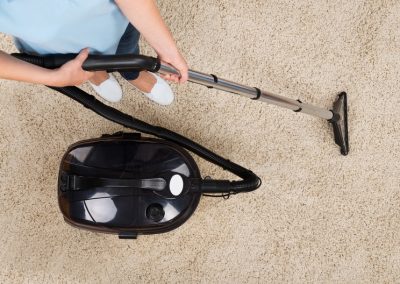 Woman Vacuuming Carpet